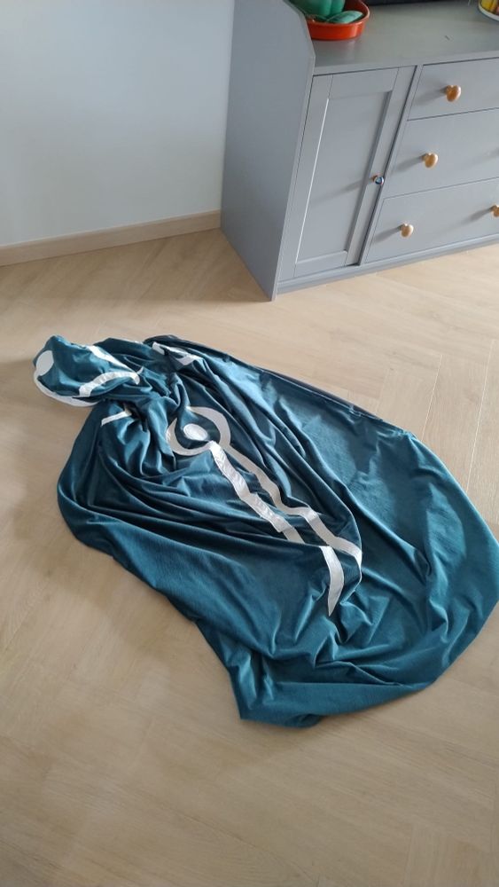 A picture of the cape of Jace Beleren, lying in a somewhat messy puddle on the floor, kinda looking like Jace himself has melted into a puddle. 