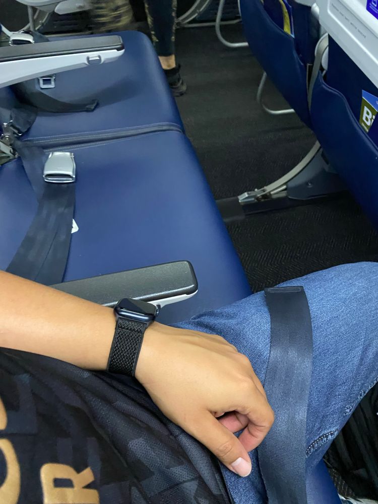 A picture of me sitting next to empty seats on an airplane. 