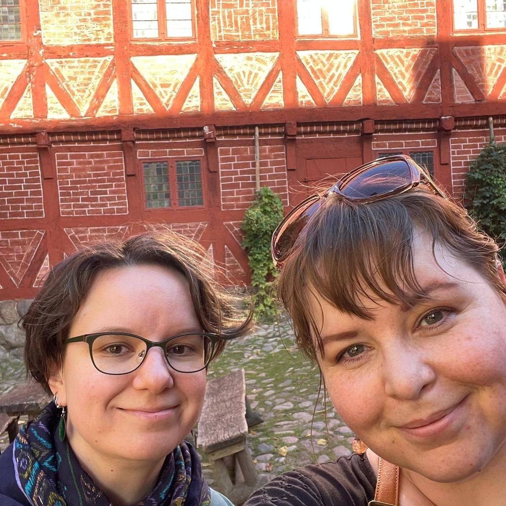 TiTaRa researchers Sara Norja and Mari-Liisa Varila looking relaxed and happy in front of a historical Danish building in Den Gamle Byn