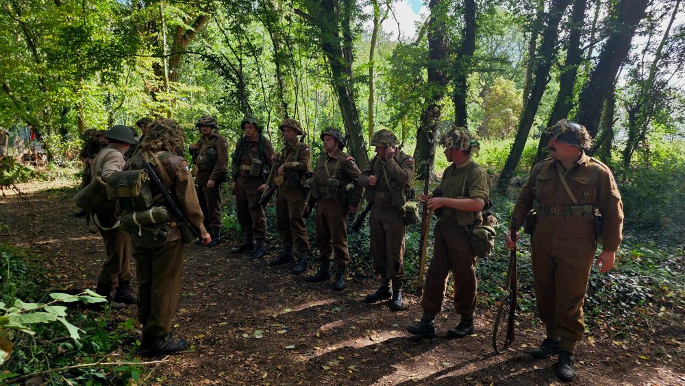 Troops being inspected in a forest.