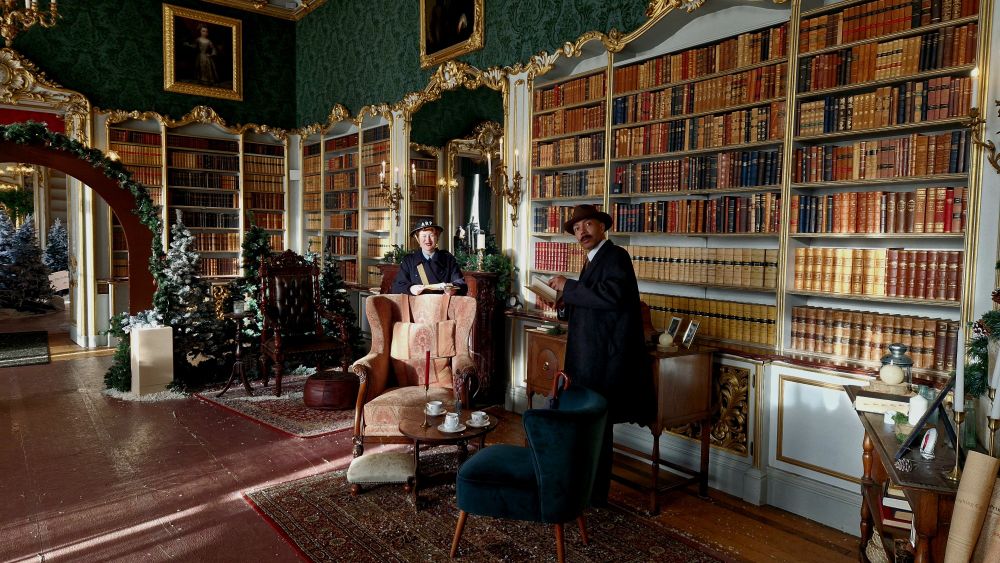 The library decorated as Mr Tumnus's house with a lady dressed as an Warden & a gentleman dressed as a 1940s gent.