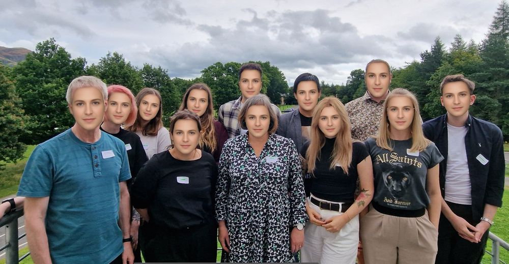 A group of researchers standing outside a building. At first glance they look like different people because they have distinctive hairstyles and are wearing different clothes. But their faces are in fact identical and were generated by averaging many faces. This image illustrates how some people with face blindness (prosopagnosia) find it very difficult to tell faces apart despite seeing them clearly.   