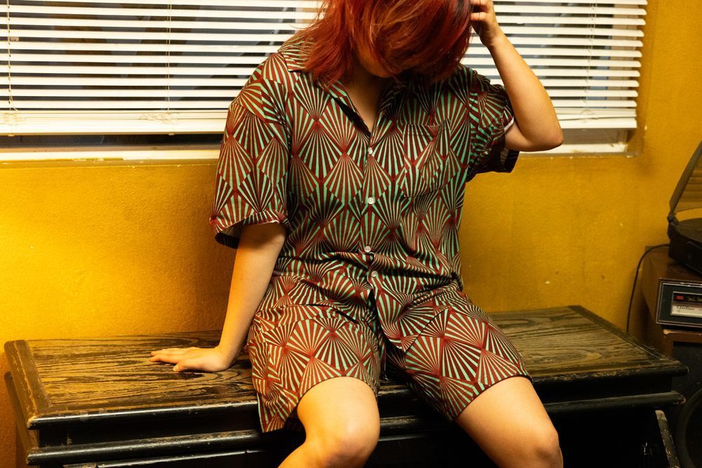 Button-up shirt and shorts in a matching PJ set featuring the wallpaper design from Control's Ashtray Maze.