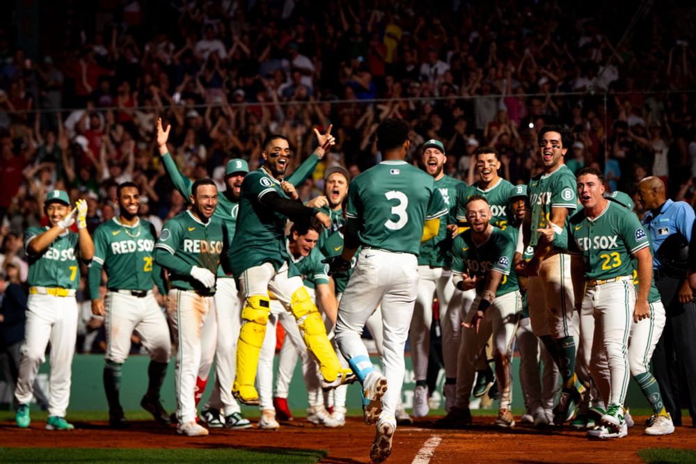 Cedanne Rafaela coming home after hitting a walk off home run, the remainder of the team dressed in City Connect Monster green jerseys there to meet him, July 11, 2025. 