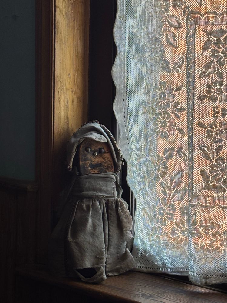A shoe doll on a window seal