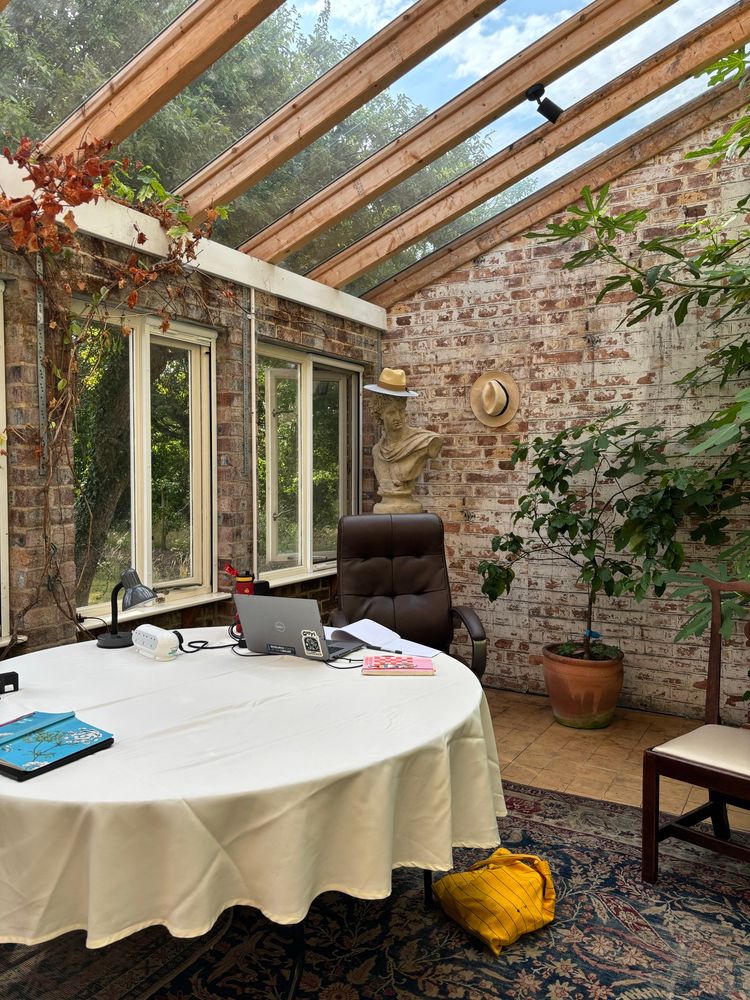 A summer house with a table and chairs 