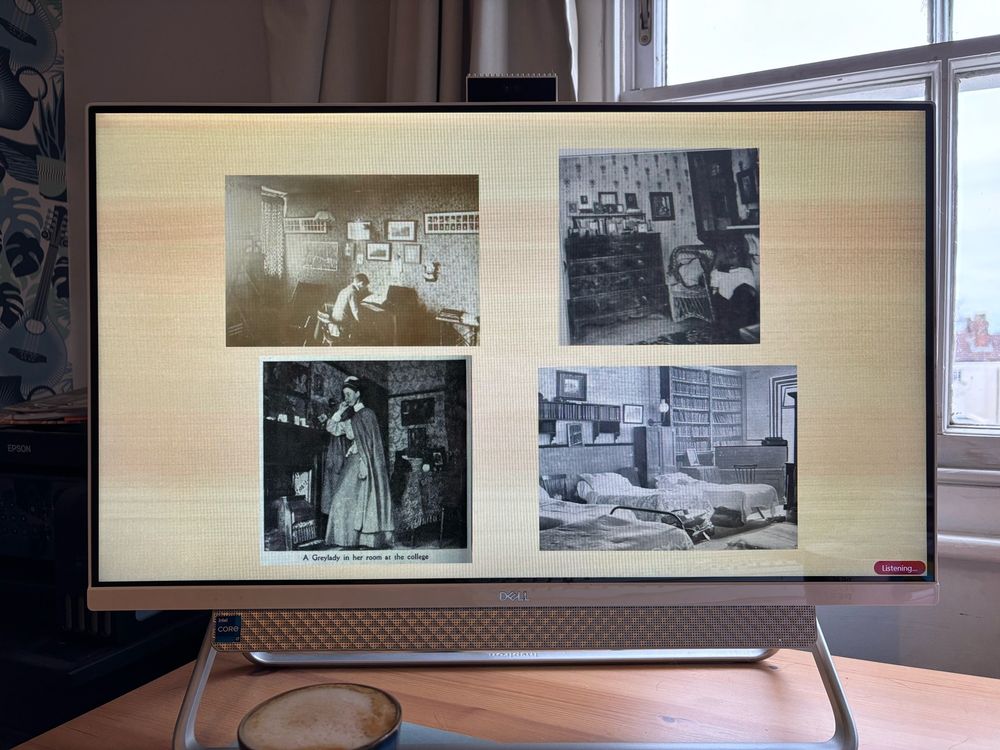 A PC screen with a PowerPoint slide of for black and white pictures of Edwardian bedrooms. The 2 images on the left have 2 people in them. 