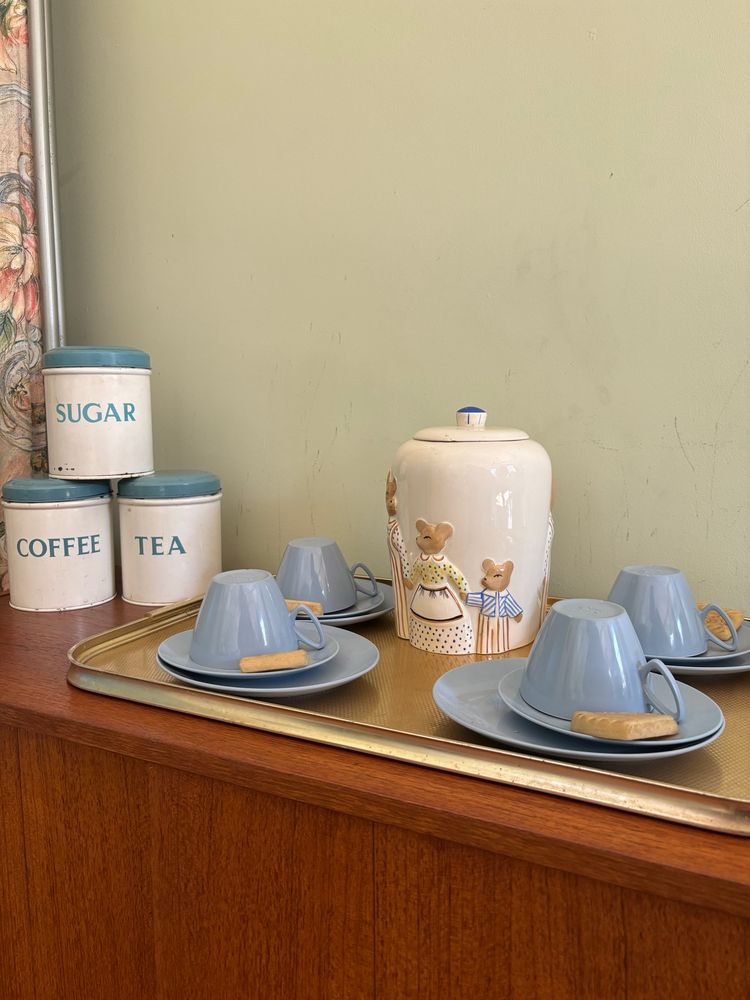 Cups and saucers with a biscuit tone and candies 