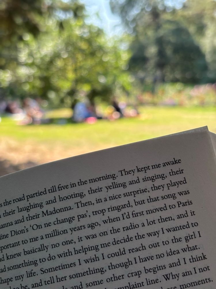 A book page with people in the distance blurred 