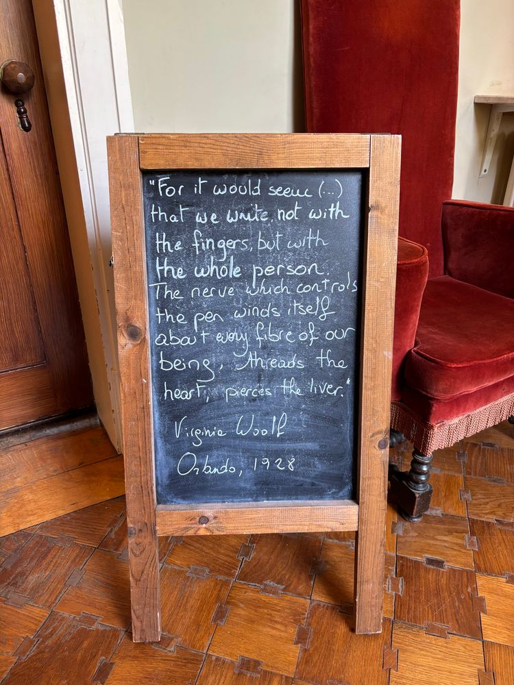 Quote on a chalkboard that reads 

"For it would seem (...) that we write not with the fingers, but with the whole person. The nerve which controls the pen winds itself about every fibre of our being, threads the heart, pierces the liver.
Virginia Woolf

Orlando, 1928
