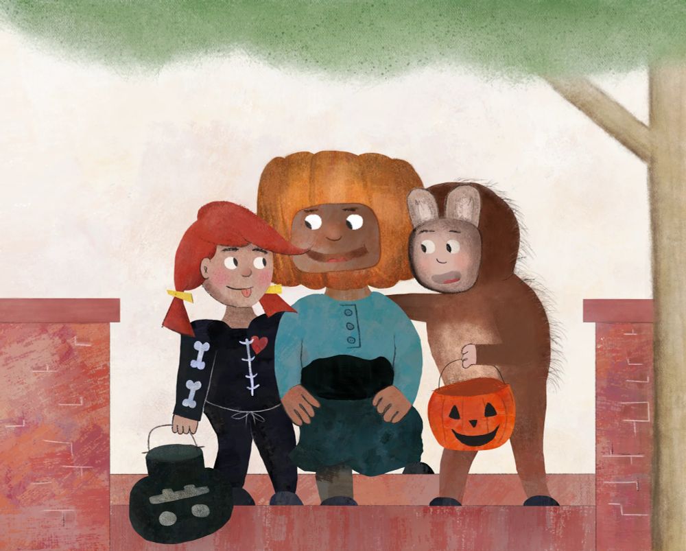 Three children in Halloween costumes stand together smiling outdoors. The child on the left wears a black skeleton outfit with a red heart on the chest and carries a black-coloured skull trick-or-treat bag. The child in the middle wears a pumpkin costume with a large pumpkin-shaped headpiece and a blue shirt. The child on the right is dressed as a brown bear or mouse, and holds an orange pumpkin-shaped candy bucket. They stand on a brick walkway beneath a tree, enjoying a lighthearted Halloween moment.