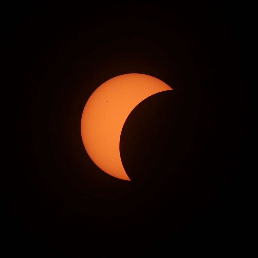 Moon passes over the view of the Sun - Approximately 50% of the Sun is covered by the moon.