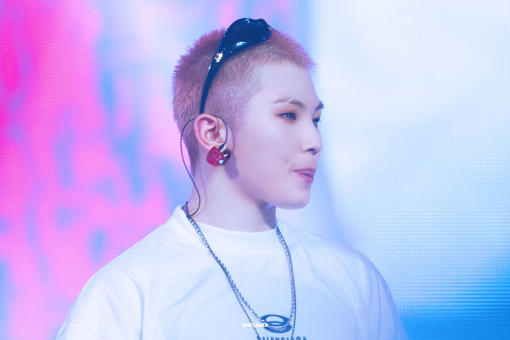 Image of Lee Jihoon taken from the howoo fan concert where his head is shaved and he looks remarkably peach-adjacent. 