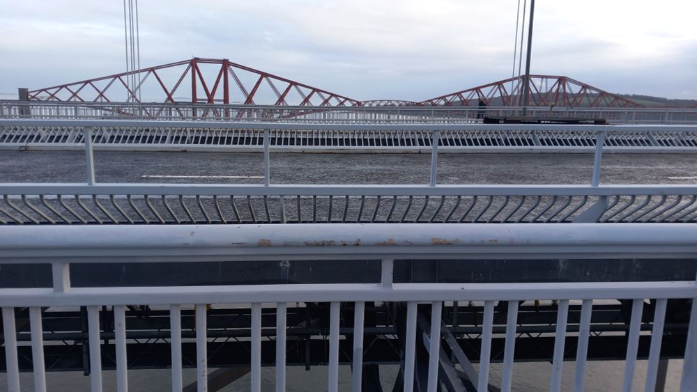 Forth bridge viewed in distance from empty forth road bridge