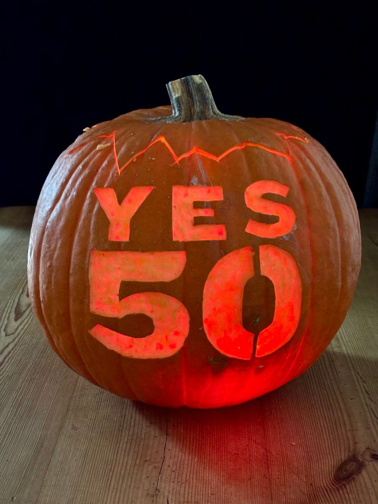 Pumpkin carved with the slogan ”Yes on 50”