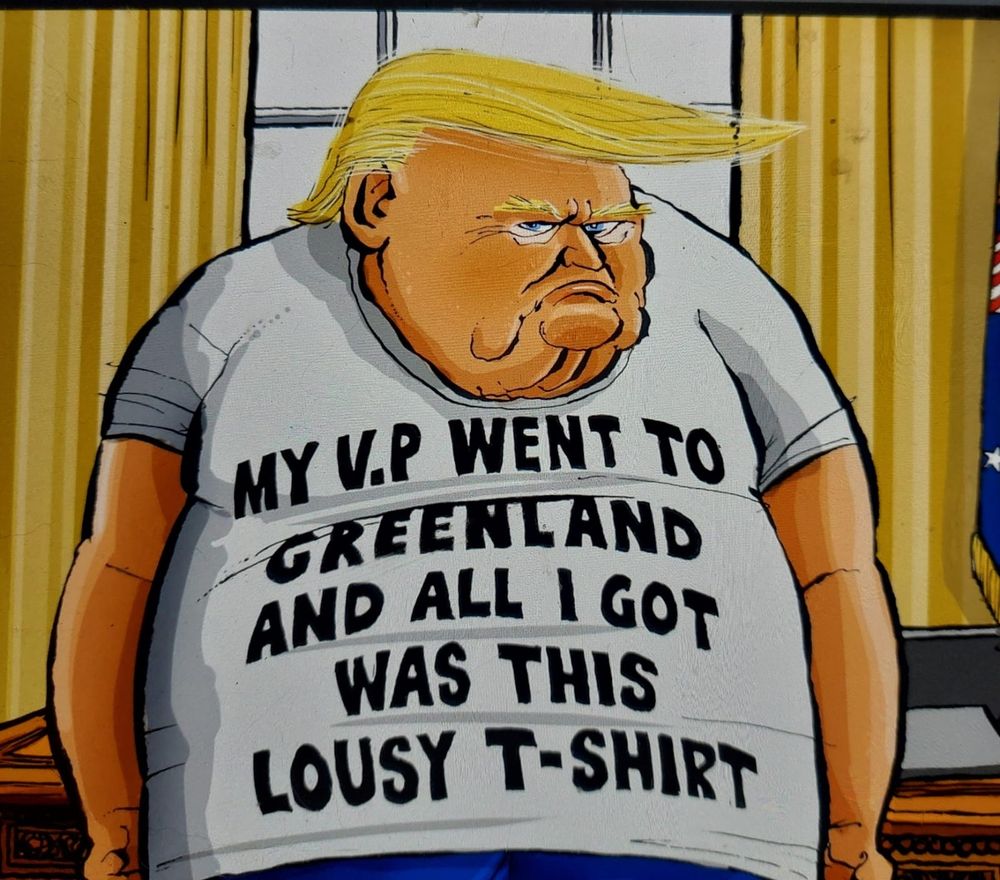 A cartoon image of trump. There is a window behind him with yellow curtains. he is wearing a white t-shirt with black text. Trump is leaning on the oval desk. 