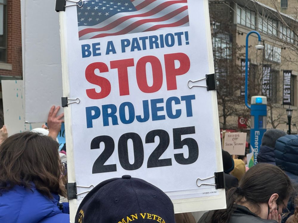 Protest sign: Be a patriot Stop Project 2025