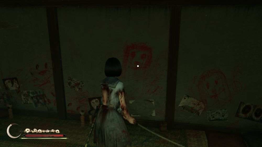 hinko stares at a drawing, made with red crayon, on the wall. it seems to be staring back at her.