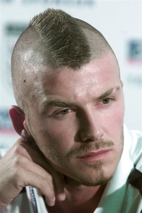 Color photo portrait of a man with a retro punk mohawk hairstyle.