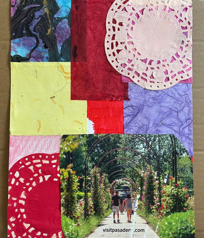 Base layer of Valentine’s collage — patchwork of textured paper in red, purple, pale yellow; pink & red doilies; magazine photo of a rose arch walkway