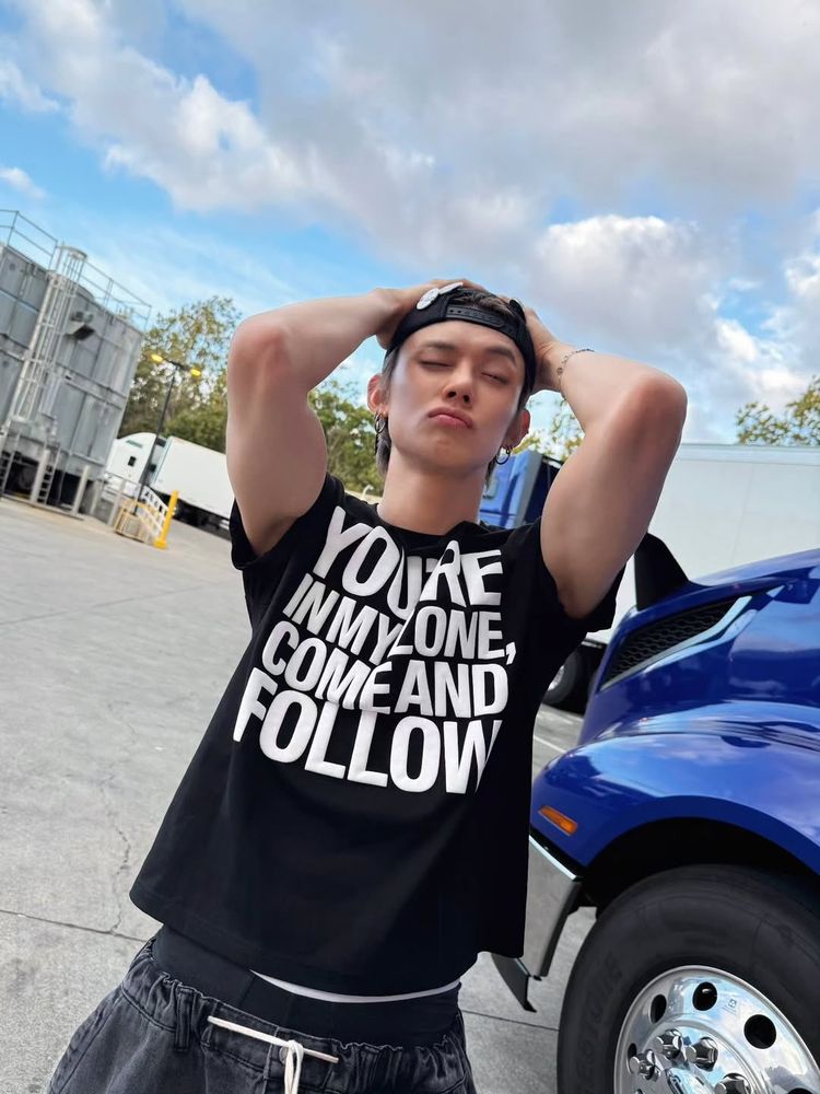 I’m not ignoring the No Labels promo, just wanna sprinkle in some older pics along with the new!! This IS one of the newer ig pics YJ posted. Yeonjun is in a parking lot by the semi trucks. Low black drawstring jeans, dark undies peeking out. Black tee with white letters saying “you’re in my zone, come and follow”. Backwards bars wall cap. Arms up & hands are on the cap. Yeonjun is trying to wink. He makes everything look so cool?!!?!!!
