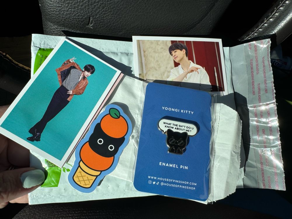My package from House of Pins. Includes a Yoongi pin, a sticker, and 2 photo cards. 