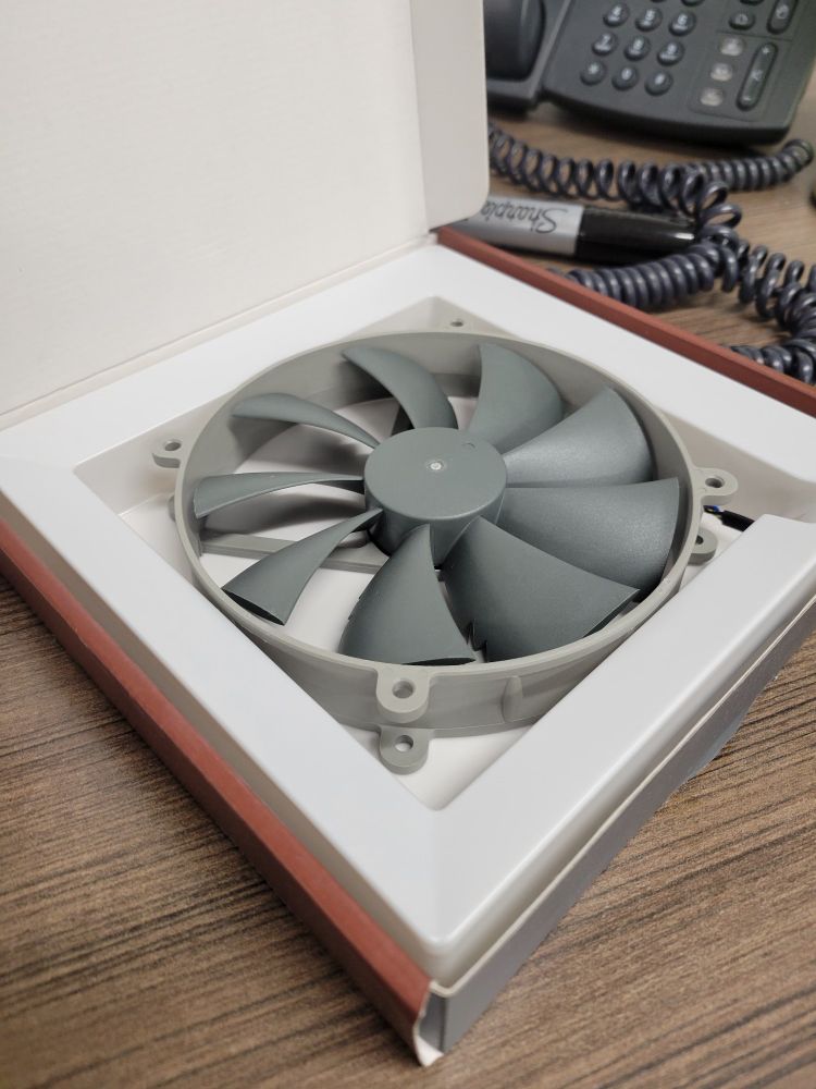 a grey Notcua 140mm pc fan in a box.