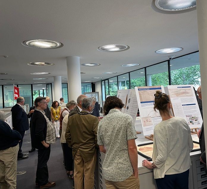 People around a table looking at boards and documents.
