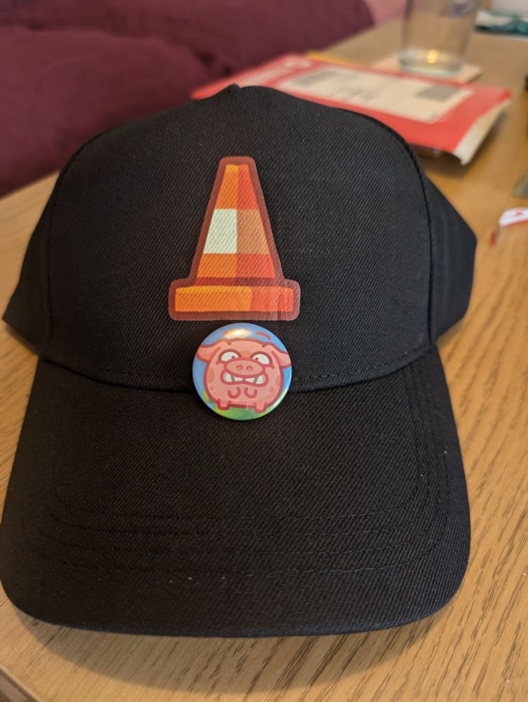 The badge is placed on the cap so it looks like the pig is wearing the cone