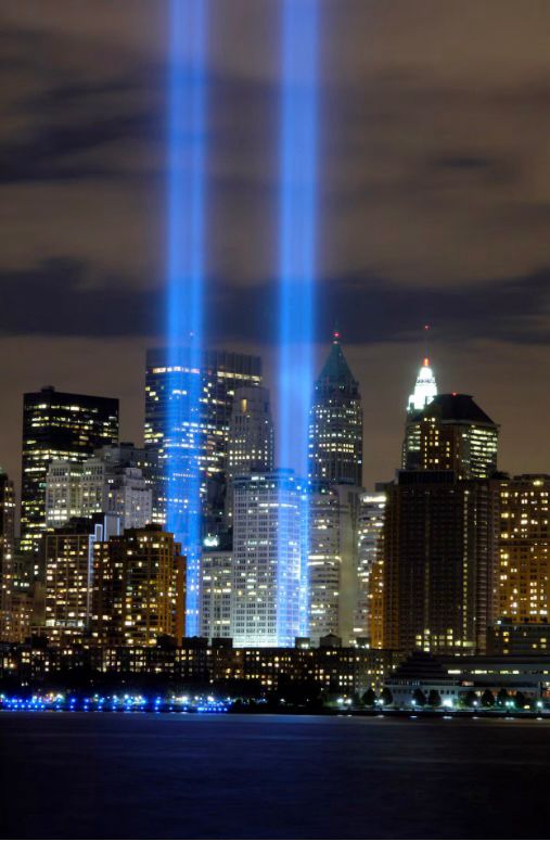 NY skyline with 2 beams of light representing the Twin Towers.