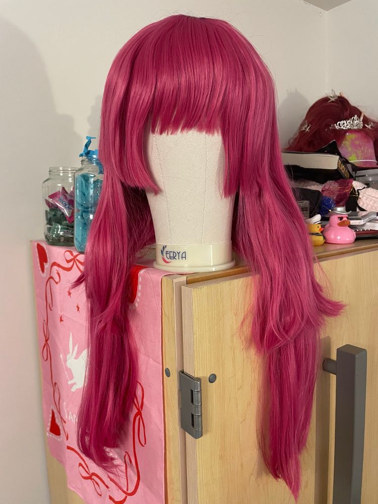 long, bright pink wig styled into a hime cut