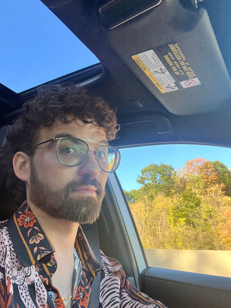 A man in glasses looks startled towards a camera