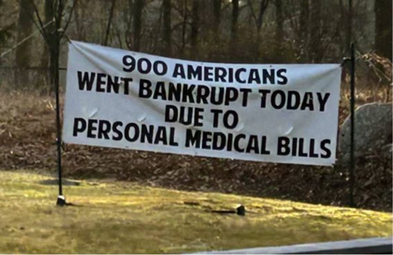 A banner that reads “900 AMERICANS
WENT BANKRUPT TODAY DUE TO PERSONAL MEDICAL BILLS”