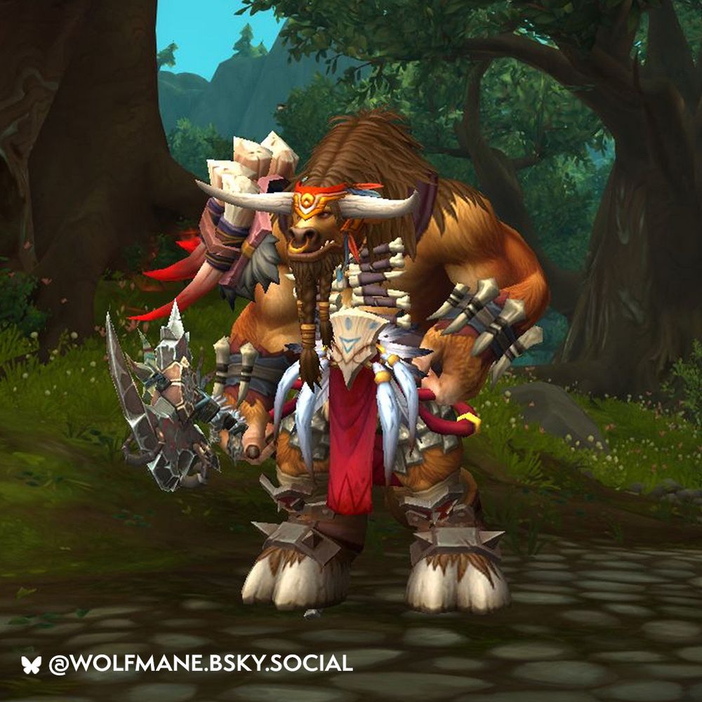 Standing tall in the center of the image is a large brown Tauren. The armor covers the Tauren very minimally, and it features a lot of ivory tusks, bones, and feathers as decoration. The belt features a large wooden buckle adorned with numerous long, flowing white feathers and gold rings at their bases. The Tauren has a large axe equipped in their right hand; it appears to be black and made of a rough stone-like material with many sharp edges. The background of the image is some sort of forest, with many trees and tall green grass. The Tauren is on top of a dirt road with some small stones and is moooving their way through the forest.