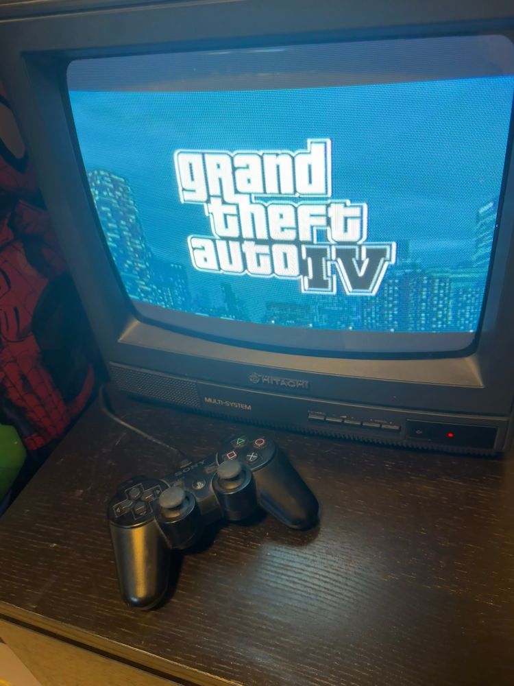 Hitachi CRT TV with the Grand Theft Auto IV title card displayed from a PlayStation 3.