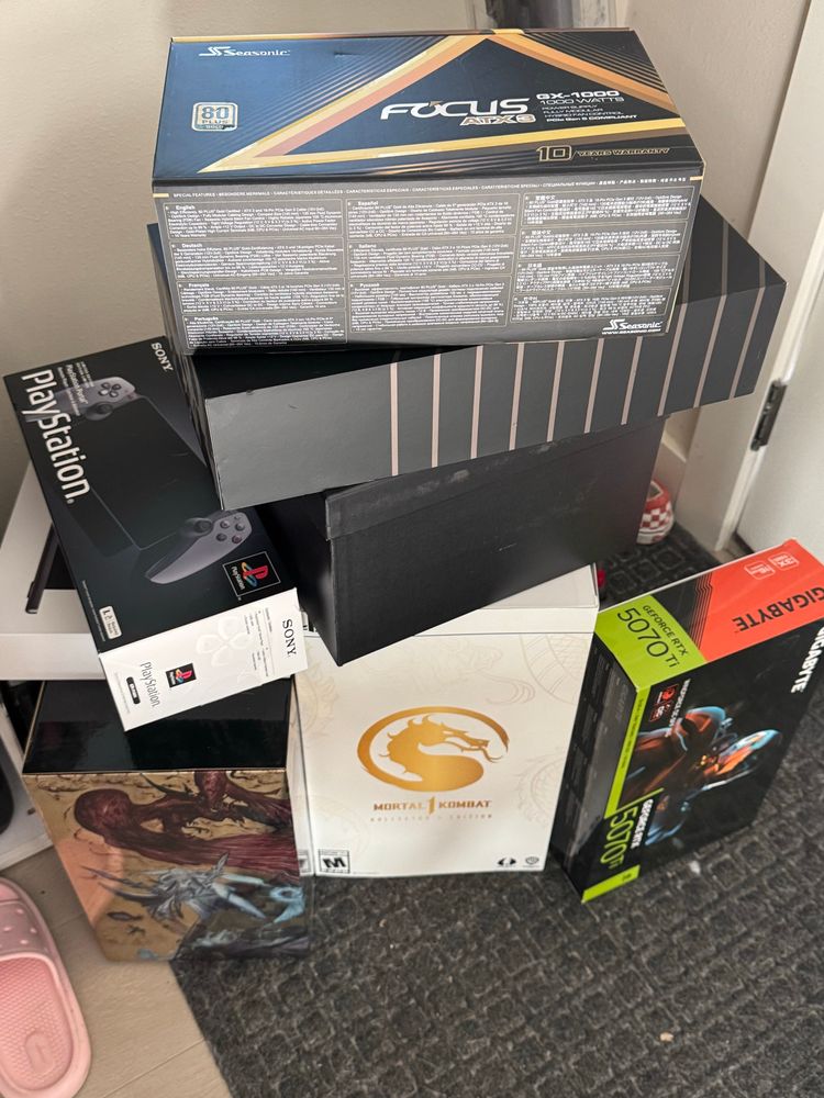 A pile of boxes ranging from PC parts to video game collector’s editions.