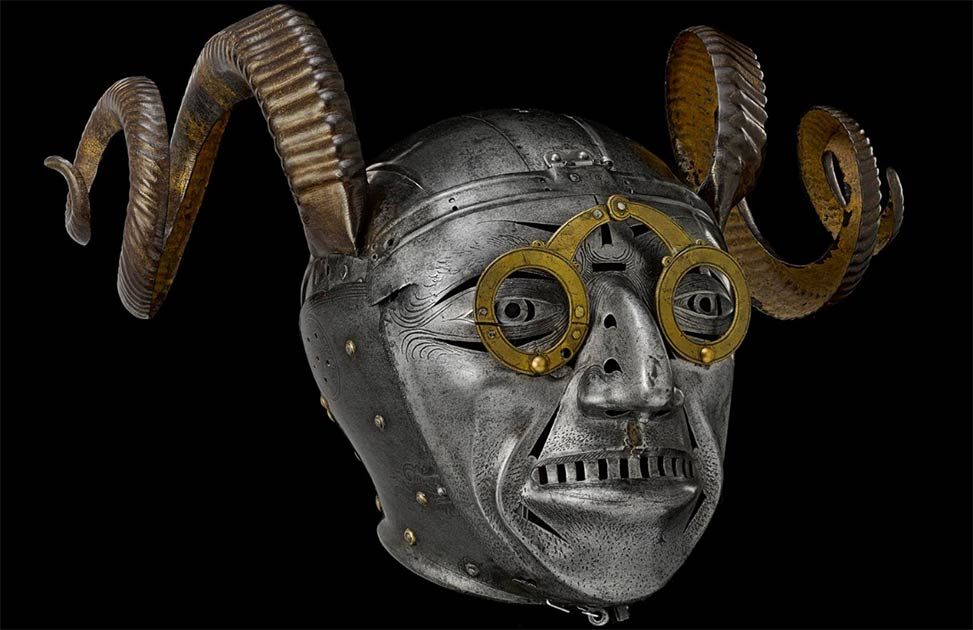 The horned helmet of Henry VIII, part of a full suit of armour made by Konrad Seusenhofer between 1511 and 1514. The armour was a gift from the Holy Roman Emperor Maximilian I. The helmet includes a face piece with protruding eyes, a toothy grimace and a stubbly chin with ram's horns rivetted to its upper part.