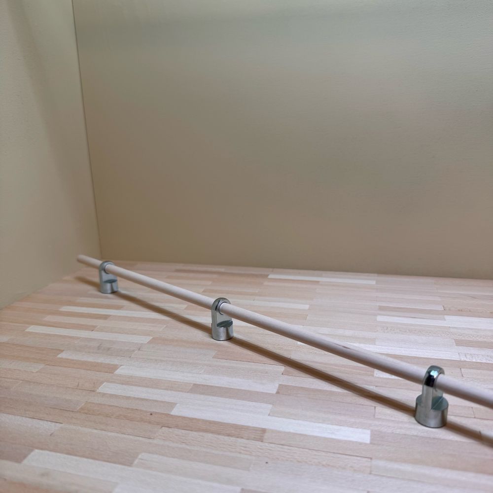 A dowel threaded through some chonky eyelets.