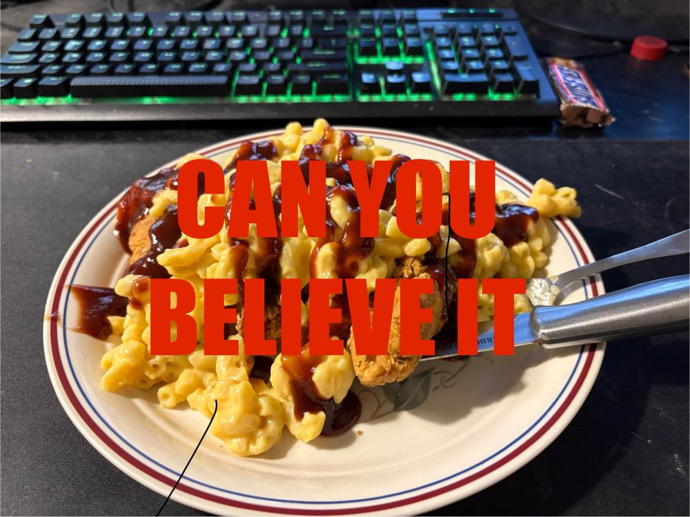 A big big plate of chicken tenders covered in macaroni and cheese and barbecue sauce, with a sweet snickers on the side for dessert