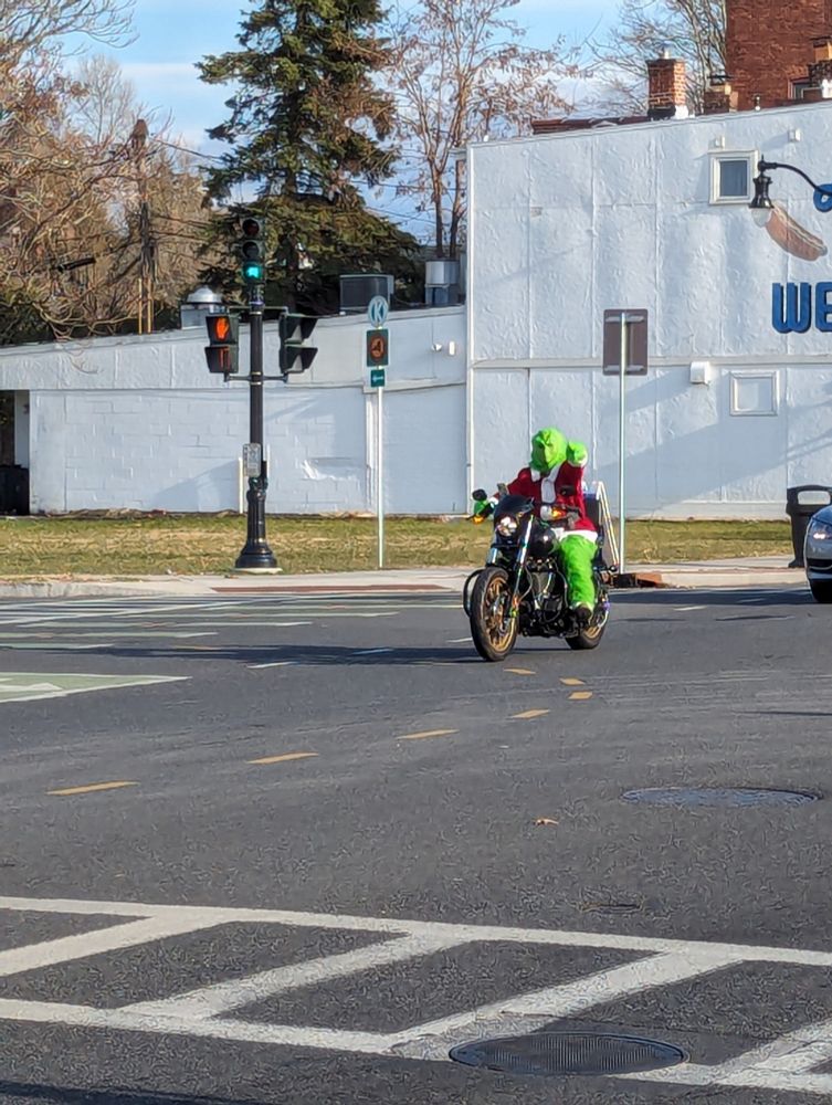 Grinch on motorcycle pointing.