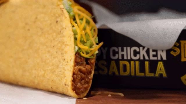 a taco sits next to a box that says chicken sadilla