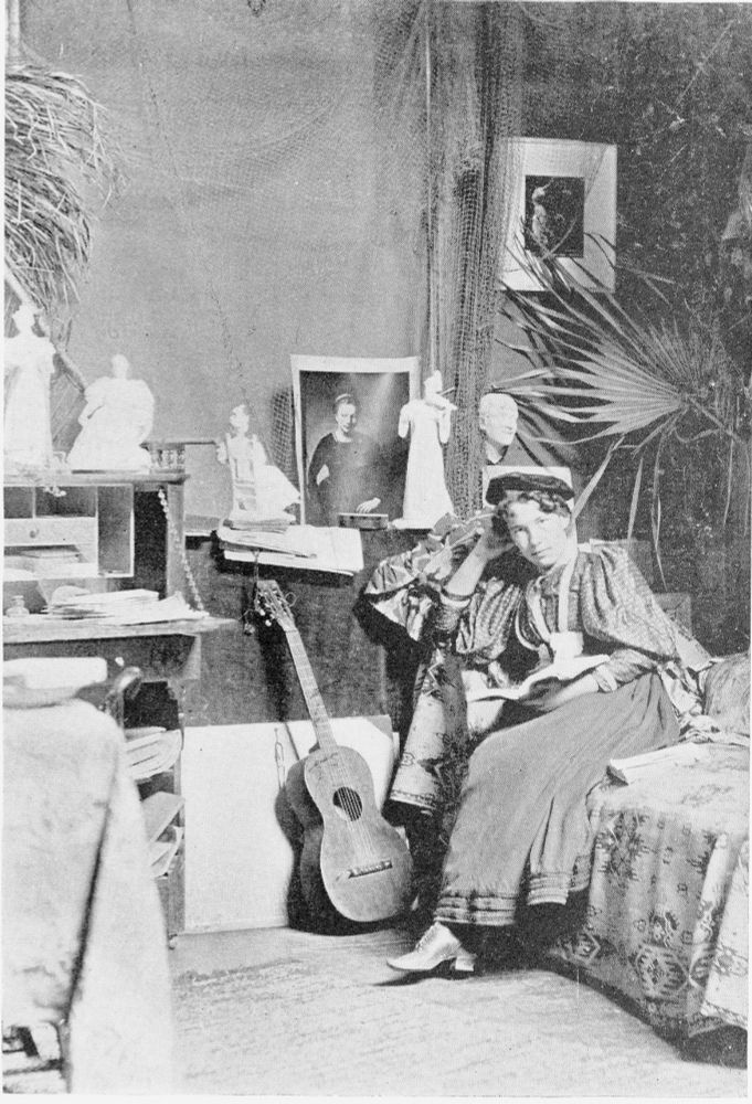 Bessie Potter (Vonnoh) in her studio in the Athenaeum Building on Van Buren Street, Chicago. Reproduced in Frank Leslie’s Illustrated Newspaper, December 9, 1897, 373; Prints & Photographs Division, Library of Congress

Black and white photograph of a woman in a long skirt and full-sleeved blouse seated on a bed in a crowded interior. Behind her are a series of small white figural sculptures.
