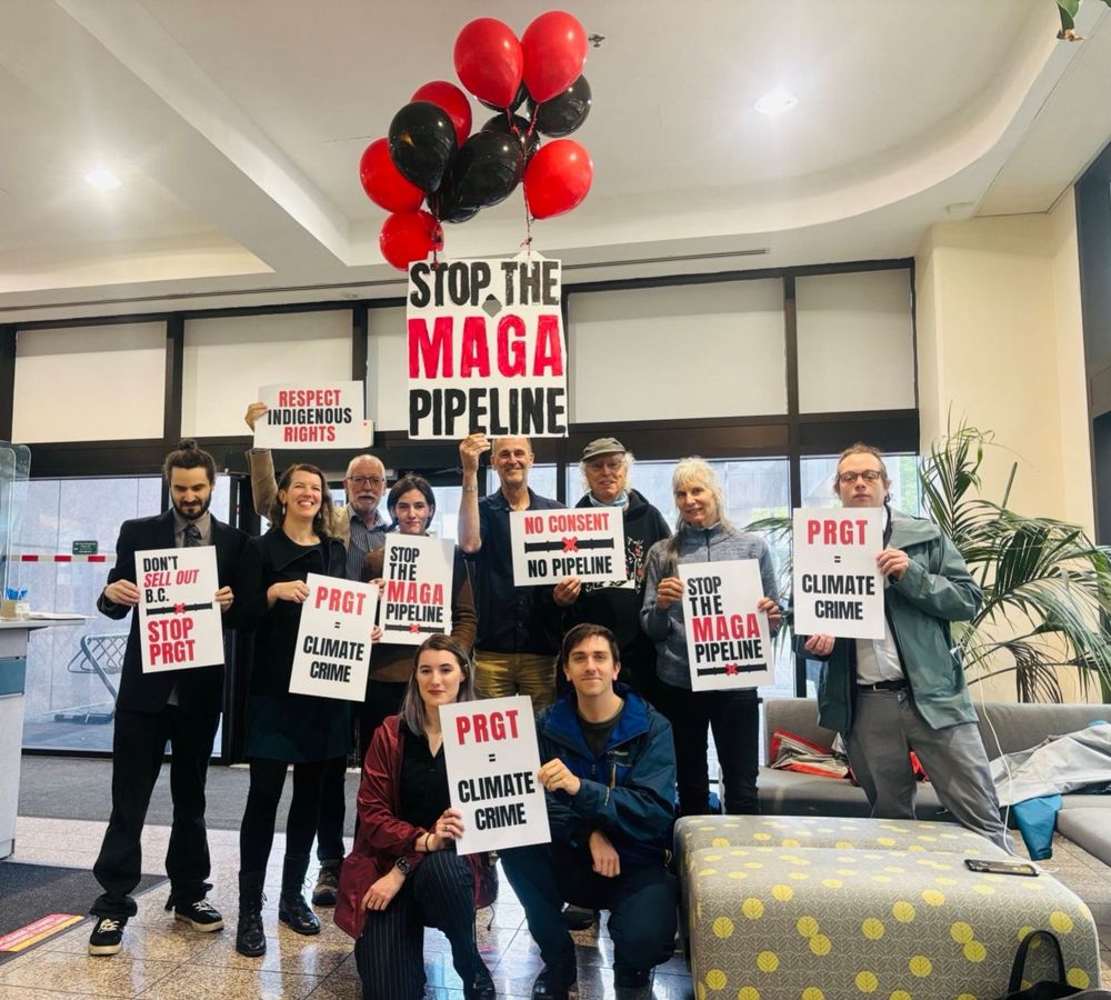 Activists inside the BC Ministry of Energy and Climate Solutions office in Victoria, holding signs that say “PRGT = climate crime” and “stop the MAGA pipeline”