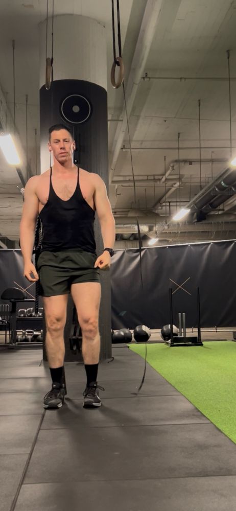 Me in a vest and shorts where my top is not quite covering my pectoral modesty. You might call it a double nip slip. I’m in a hotel gym with CrossFit equipment. 