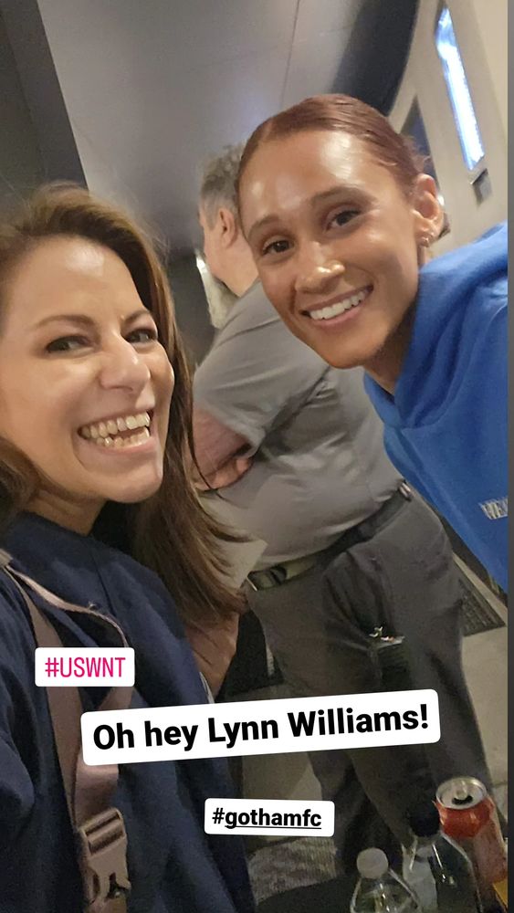 Lynn Williams on the right smiling with a fan on the left.