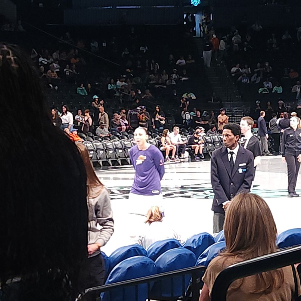 Diana Taurasi stands with her arms behind her back during a pregame warm up. 