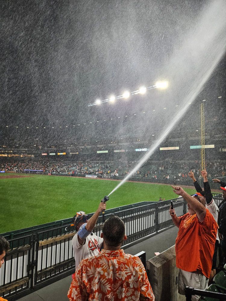 Mr. SPLASH SPRAYING THE FANS AT THE END OF EXTRA INNINGS. 