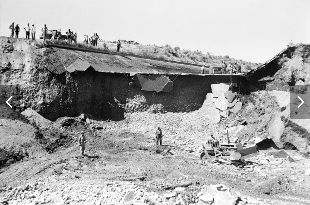 Work crews are dwarfed by the enormous breach of a 200 ft section of the New York Canal in this 1955 photo.