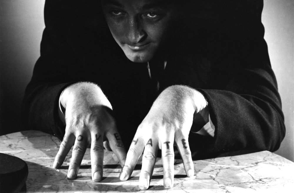 Rev Harry Powell from the film The Night of the Hunter. LOVE and HATE visible tattoos on his knuckles