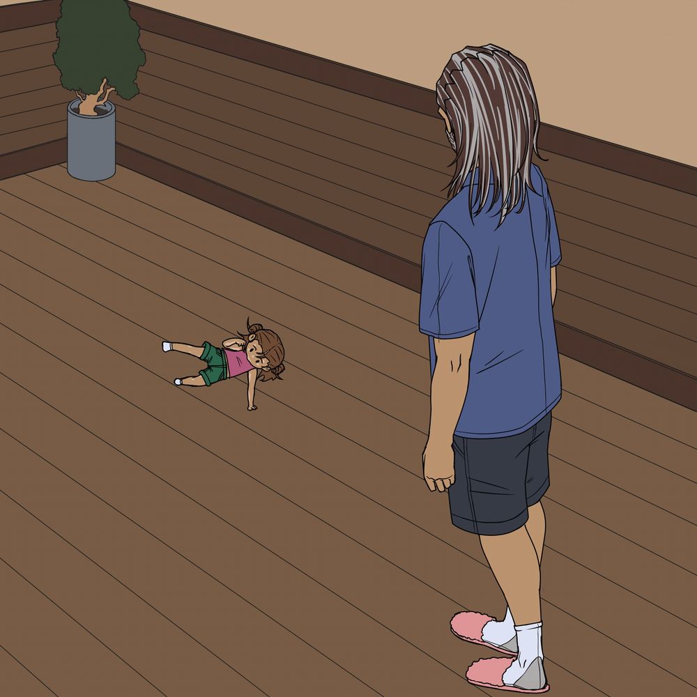 A gif of a small child with brown hair and vitiligo breakdancing in front of a man with long hair. She is swinging her legs out and around her with only her hands on the ground.